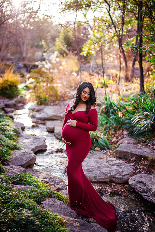 Red maternity gown pregnant woman photoshoot in the nature