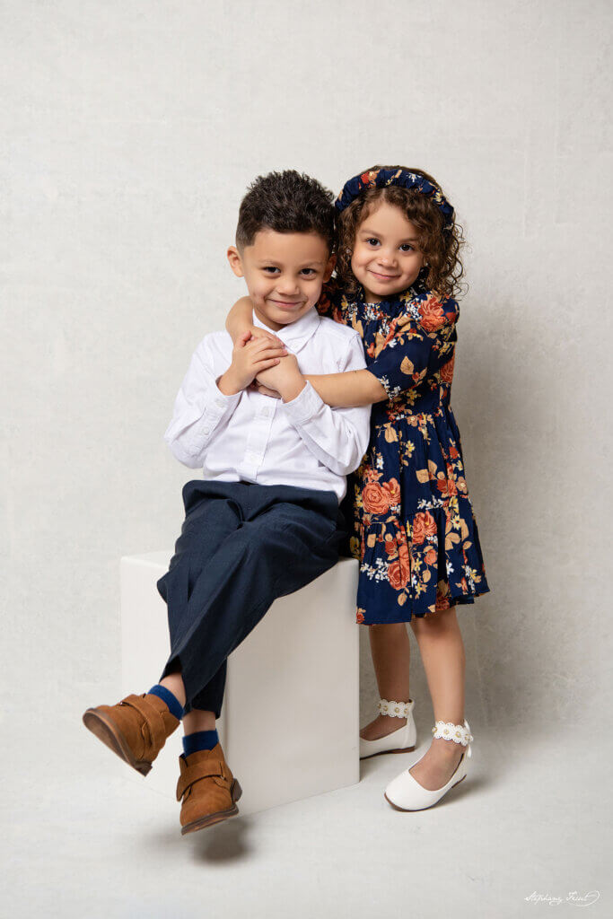 Cute brother and sister posing for our Christmas family session