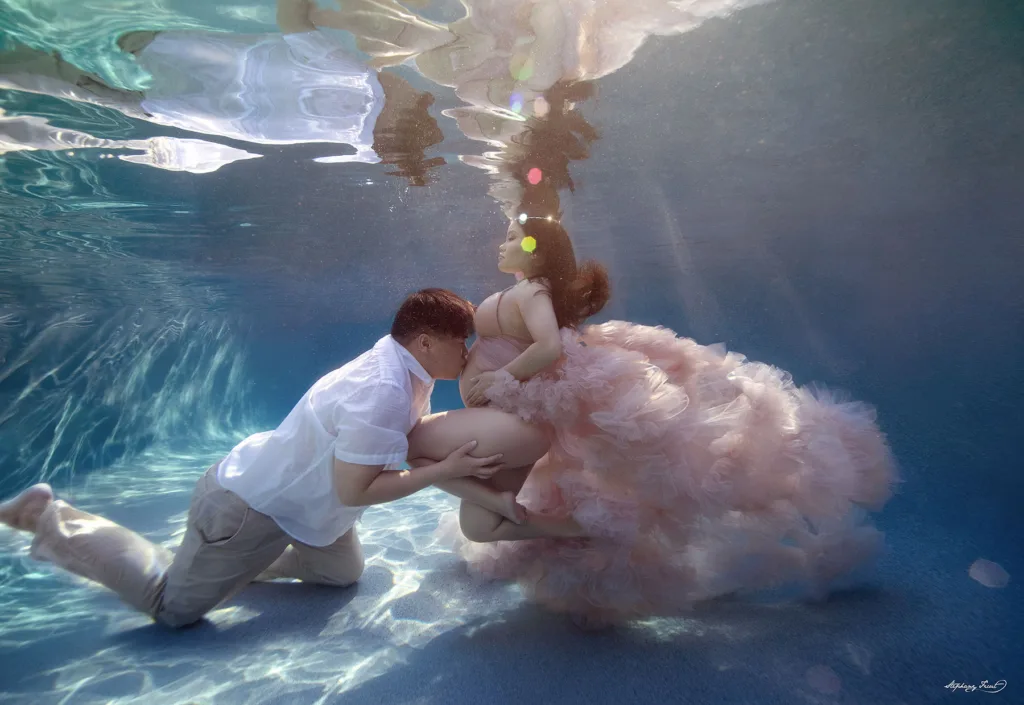 Underwater maternity maternity photo shoot in Dallas, Texas  by Stephany Ficut Photography with partner in blue water